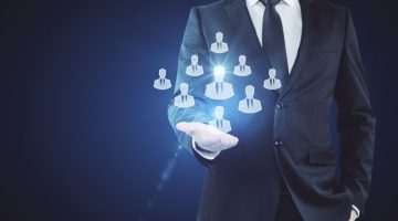 Businessman Holding Hr Hologram On Dark Background. Employer Concept