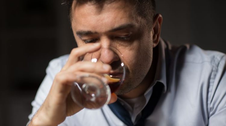 Alcoholism, Alcohol Addiction And People Concept - Close Up Of Male Alcoholic Drinking Brandy