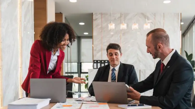 Business team Diverse colleagues gather brainstorm discuss financial statistics at office meeting