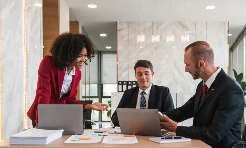Business team Diverse colleagues gather brainstorm discuss financial statistics at office meeting