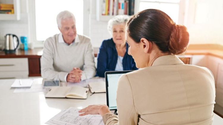 Woman Helping the elder couple to make their money work for them