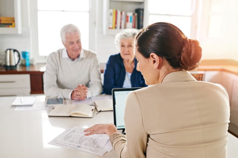 Woman Helping the elder couple to make their money work for them