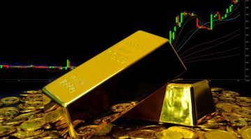 Gold bullion on pile gold coins at trading chart background