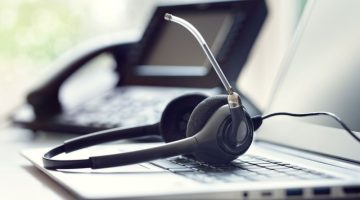 VOIP headset headphones telephone and laptop concept for communication, it support, call center and customer service help desk