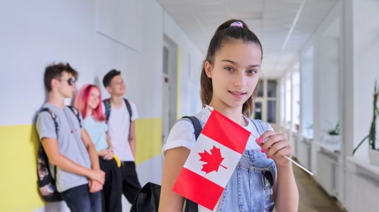 A female student with a Canadian flag inside a school