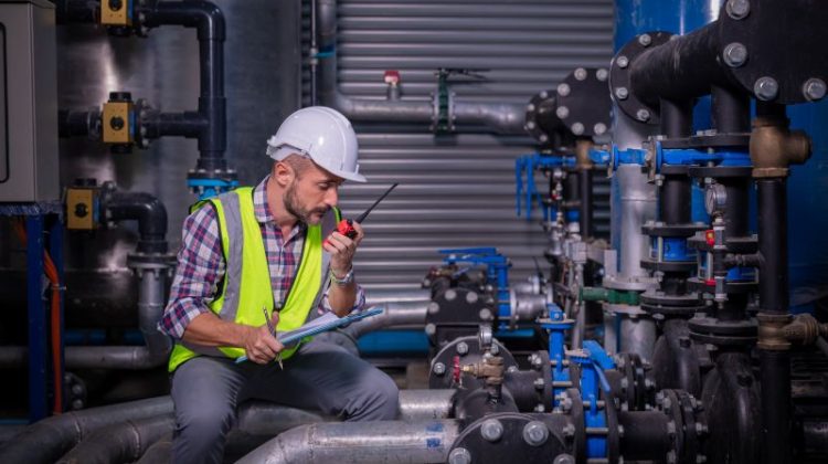 Industry engineer under checking the industry cooling tower air conditioner is water cooling tower air chiller HVAC of large industrial building to control air