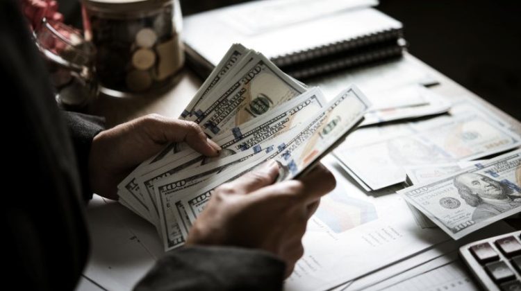 Money Counting on Table with Chart and Calculator