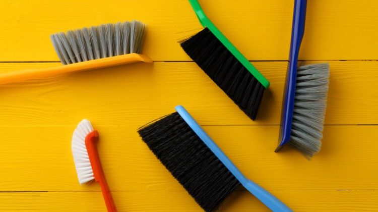 Colorful Cleaning Brushes on a Bright Yellow Background