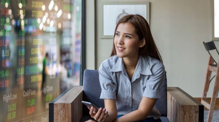 Thoughtful Woman Relaxing in Armchair with Phone