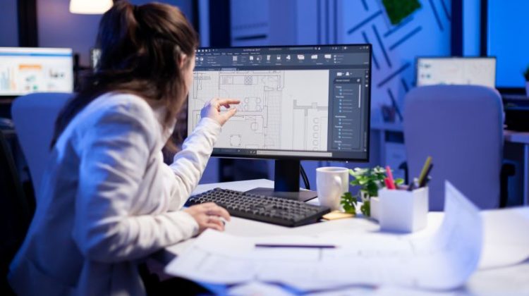 Woman Architect Working on Blueprint Design at Night