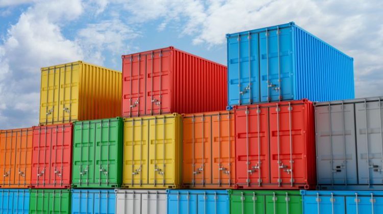 Shipping Containers Stacked Under a Cloudy Blue Sky