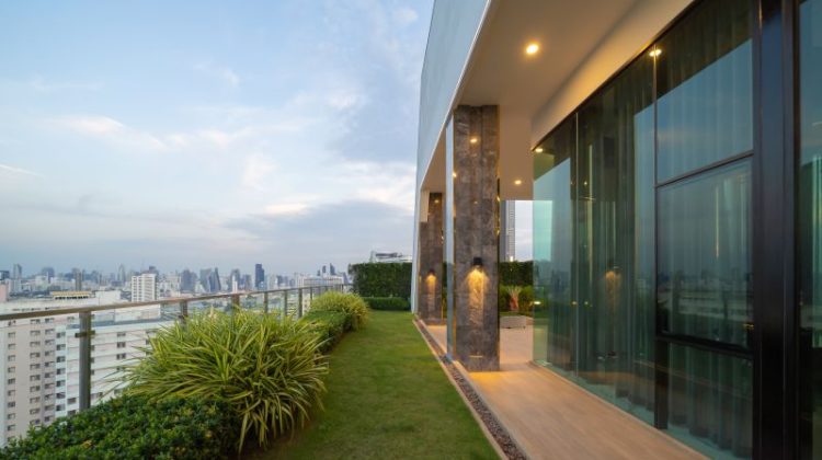 Sky garden on private rooftop of condominium or hotel, high rise architecture building, grass field