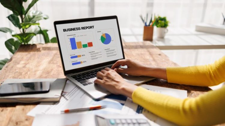 Professional Working on a Business Report on a Laptop at Home