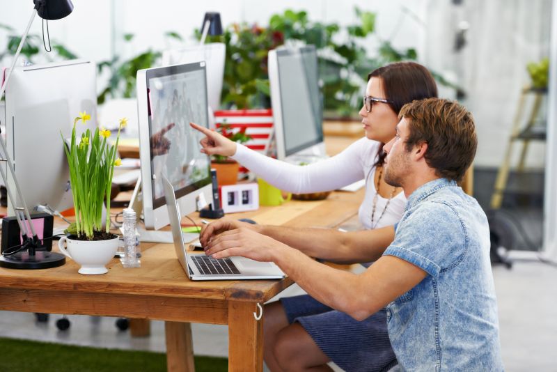Putting their minds together. Shot of young web designers at work in an office.
