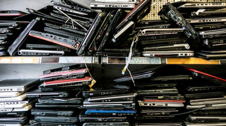 Discarded Computers Piled on Shelves in Workplace