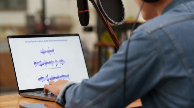 Podcaster editing audio podcast working at home studio