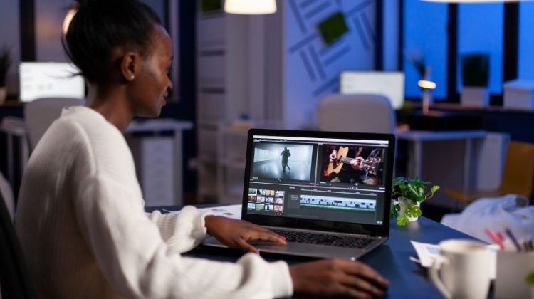 Woman Video Editing on Laptop in Modern Office