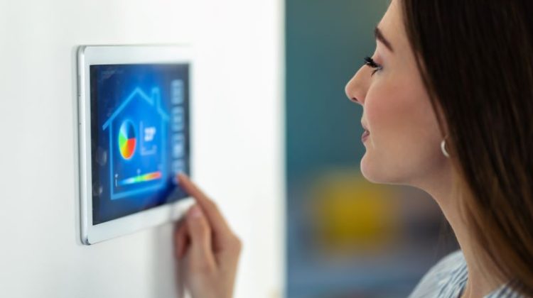 Woman Using Smart Home Automation Display Inside