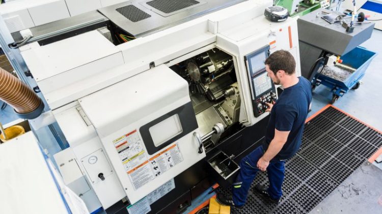 Man operating machine in industrial factory