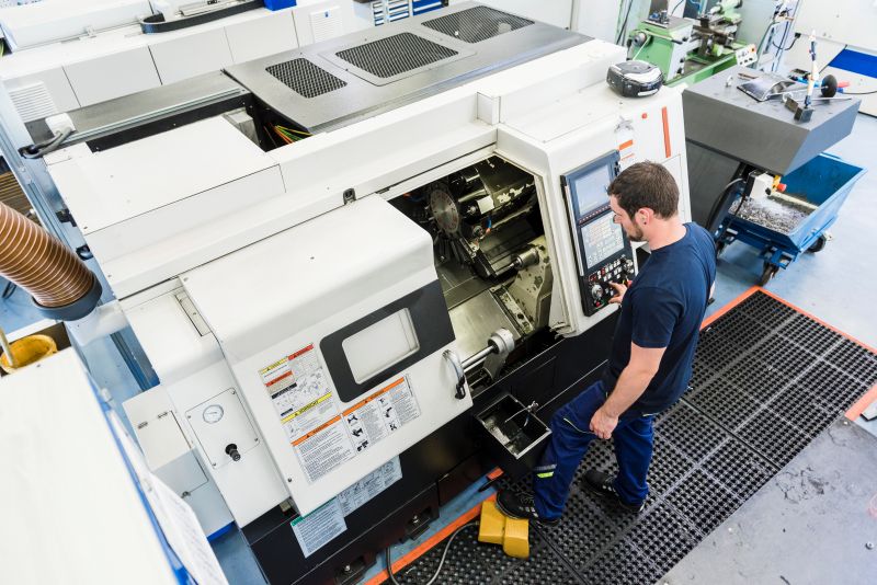 Man operating machine in industrial factory