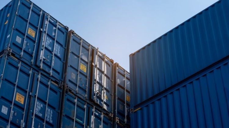 Stacked Blue Shipping Containers at a Port Facility