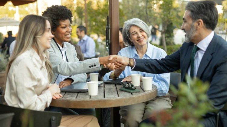 Business people shaking hands during a meeting at outdoor cafe
