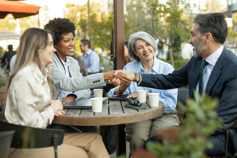 Business people shaking hands during a meeting at outdoor cafe
