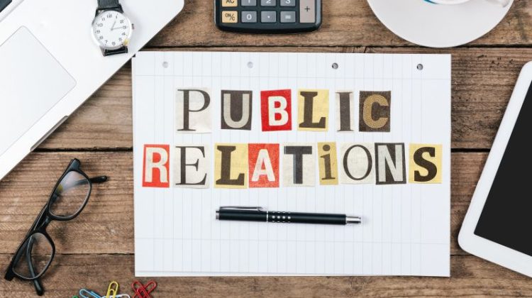 Public Relations Concept with Office Supplies on Desk