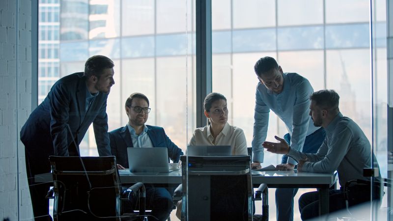 Business Team Meeting Discussing Strategy in Modern Office