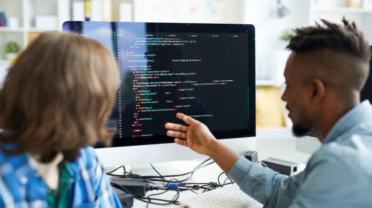 Software Developers Discussing Code at Workplace