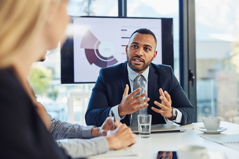 Business Meeting Discussion of Data Chart in Office