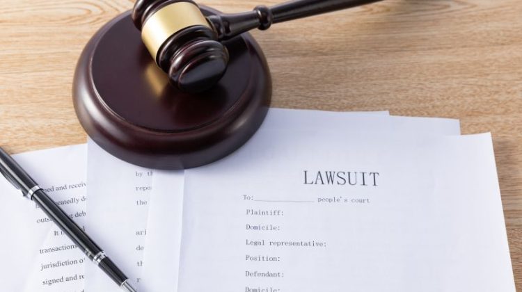 Lawsuit Document with Gavel and Pen on Desk