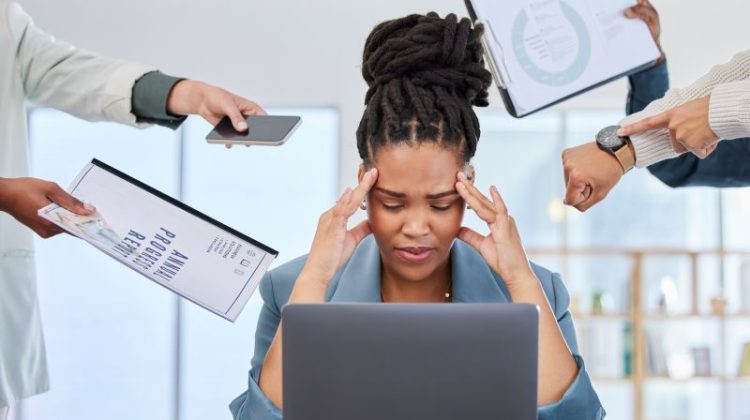 Stressed Woman Overwhelmed with Work in the Office