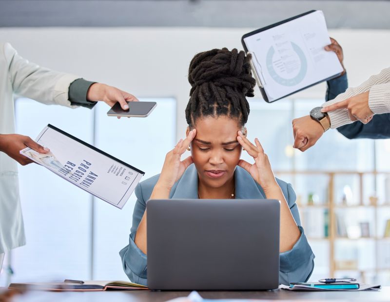 Stressed Woman Overwhelmed with Work in the Office