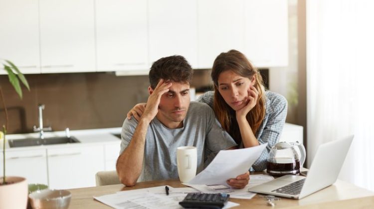 Worried Couple Reviewing Finances Together at Home