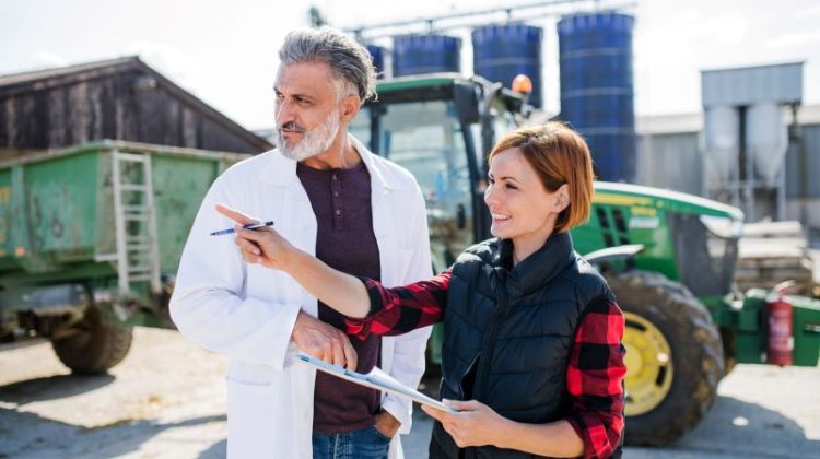 Agricultural Specialist Discusses Farm Strategy with a Farmer