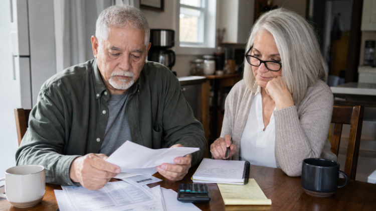 Retired couple reviewing their retirement income plan during changing market conditions.