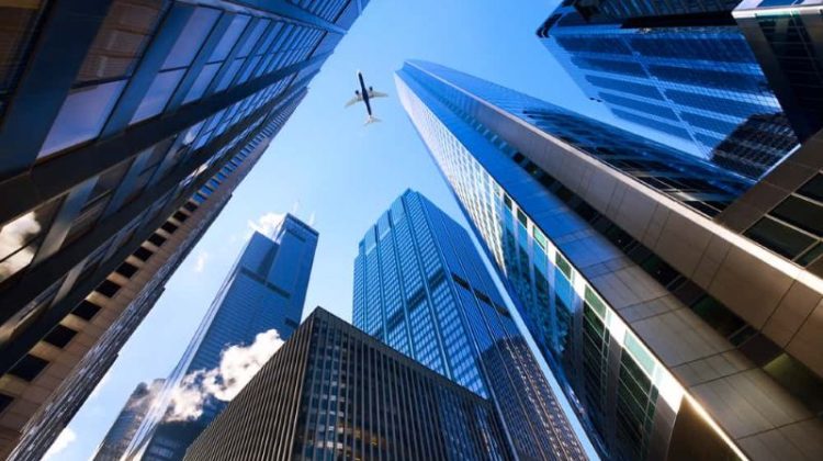 Modern office buildings viewed from below, representing business growth and long-term company value.