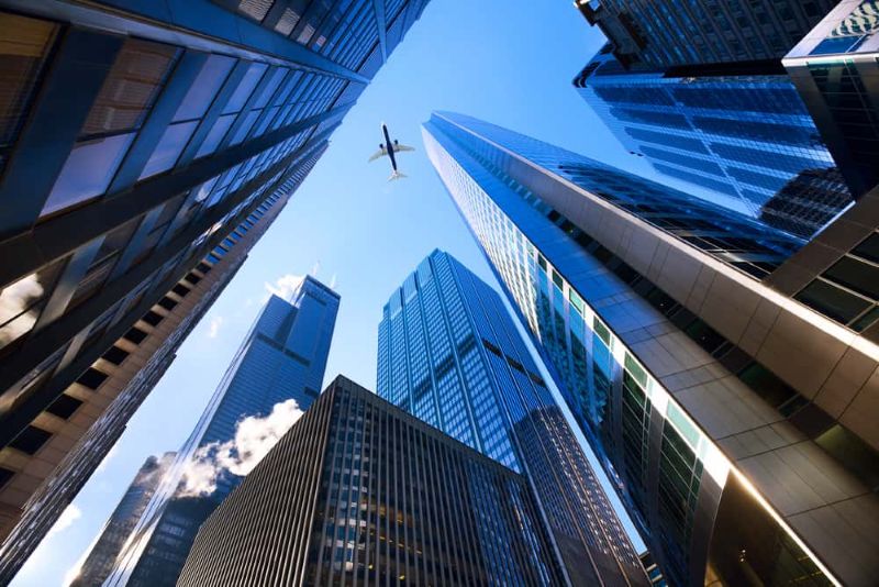 Modern office buildings viewed from below, representing business growth and long-term company value.