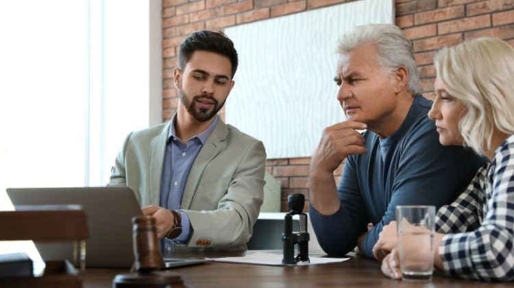 Business owners discussing succession and estate-planning documents with a professional adviser.