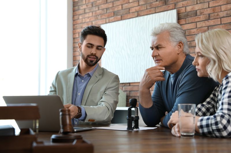 Business owners discussing succession and estate-planning documents with a professional adviser.