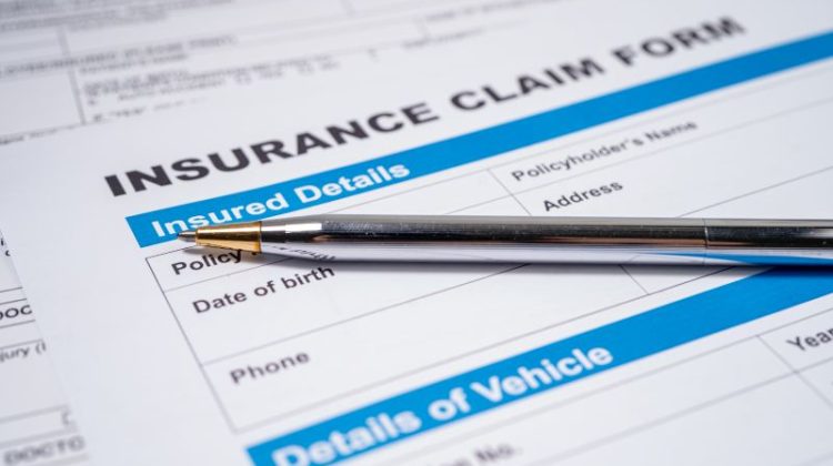Insurance Claim Form with a Silver Pen
