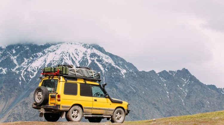 Four-wheel-drive vehicle equipped for off-road travel in mountainous terrain.