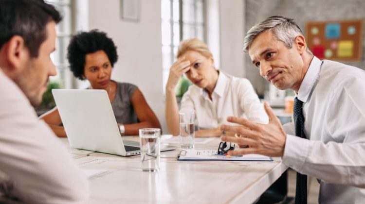 Company board members discussing financial challenges and a corporate wind-down plan during a business meeting
