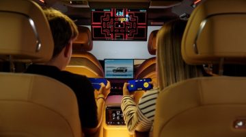 Two passengers enjoy AirConsole in-car gaming in a Zeekr, using their smartphones as controllers. The partnership marks AirConsole's entry into the Geely Auto Group ecosystem.