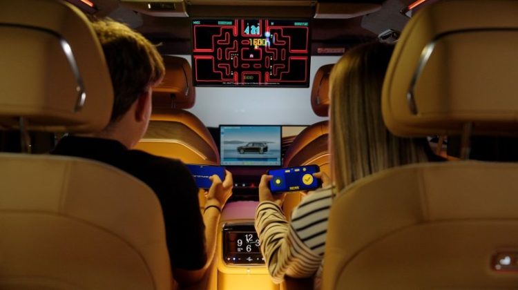 Two passengers enjoy AirConsole in-car gaming in a Zeekr, using their smartphones as controllers. The partnership marks AirConsole's entry into the Geely Auto Group ecosystem.