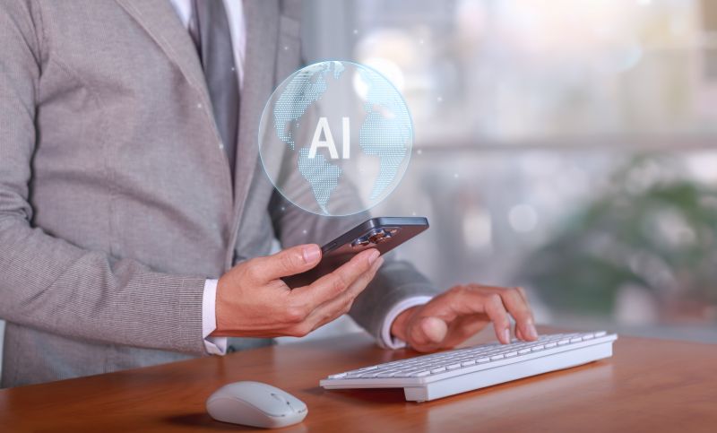 Business professional using a smartphone with an AI technology graphic.